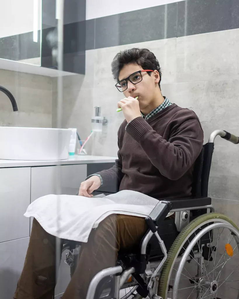 Disabled man in wheelchair brushing teeth